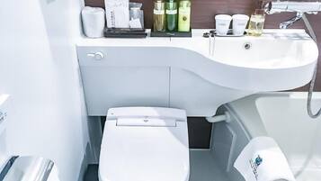 A modern bathroom with a white toilet, a sink, and various toiletries.