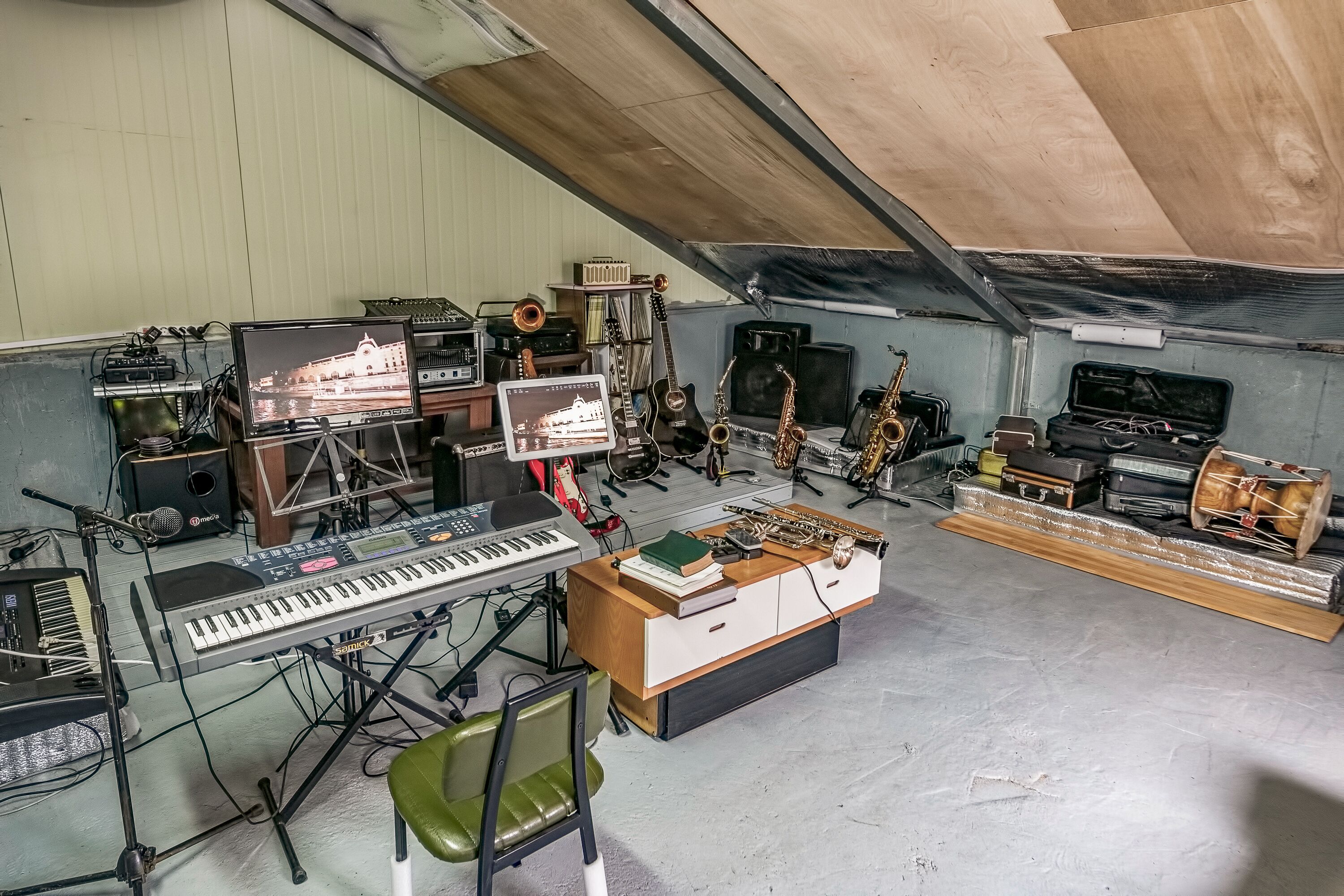 A music studio with various instruments, a keyboard, and a mixing console.
