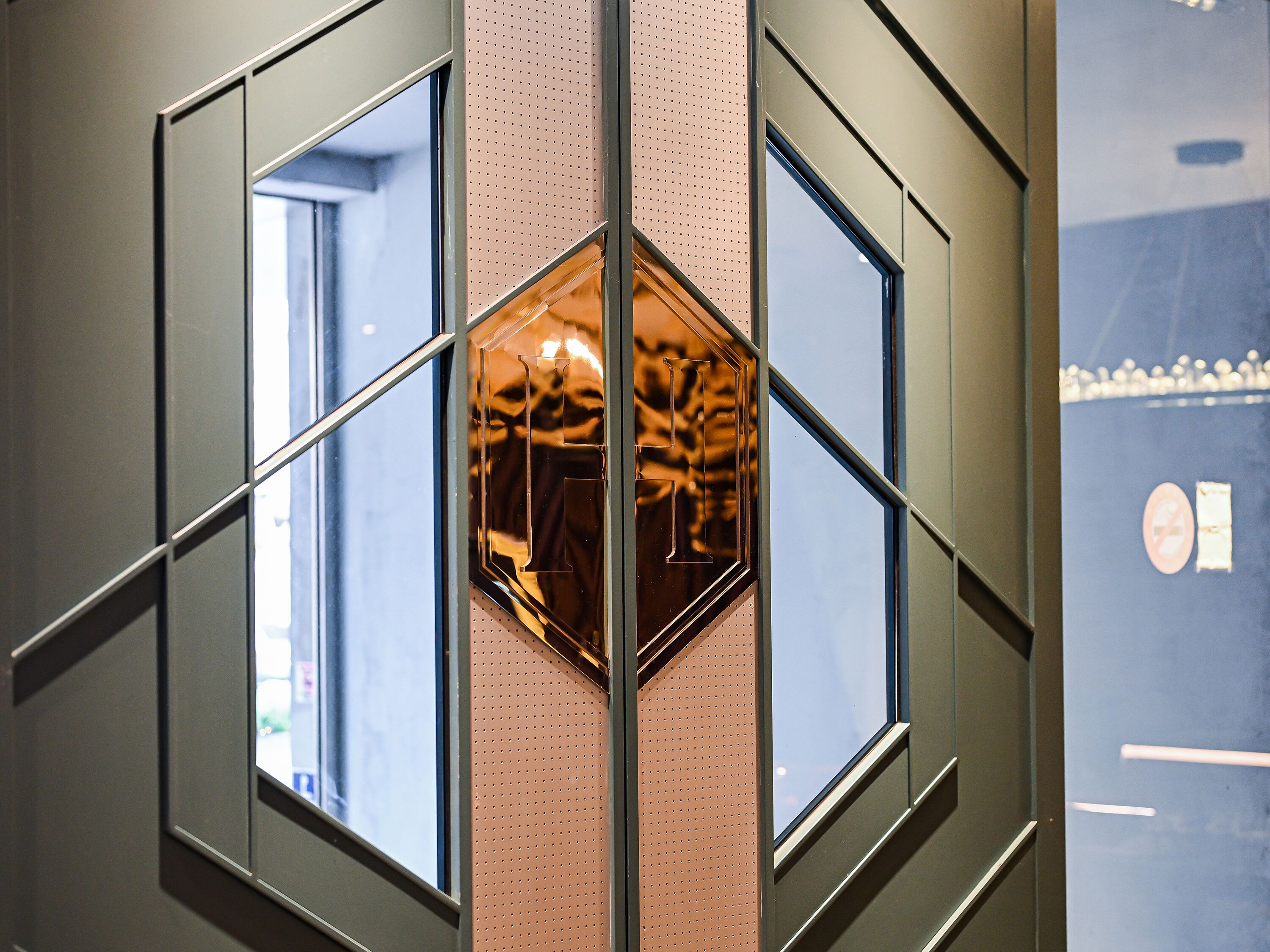 A geometric wall design with multiple windows and a central reflective hexagonal element.
