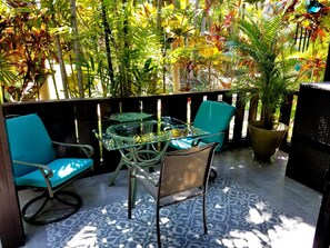 Relax in a serene outdoor space surrounded by lush greenery and comfortable seating.