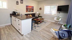 Un espacio habitable compacto con cocina, comedor y zona de estar.