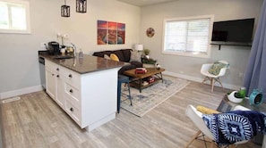 Un espacio habitable compacto con cocina, comedor y zona de estar.