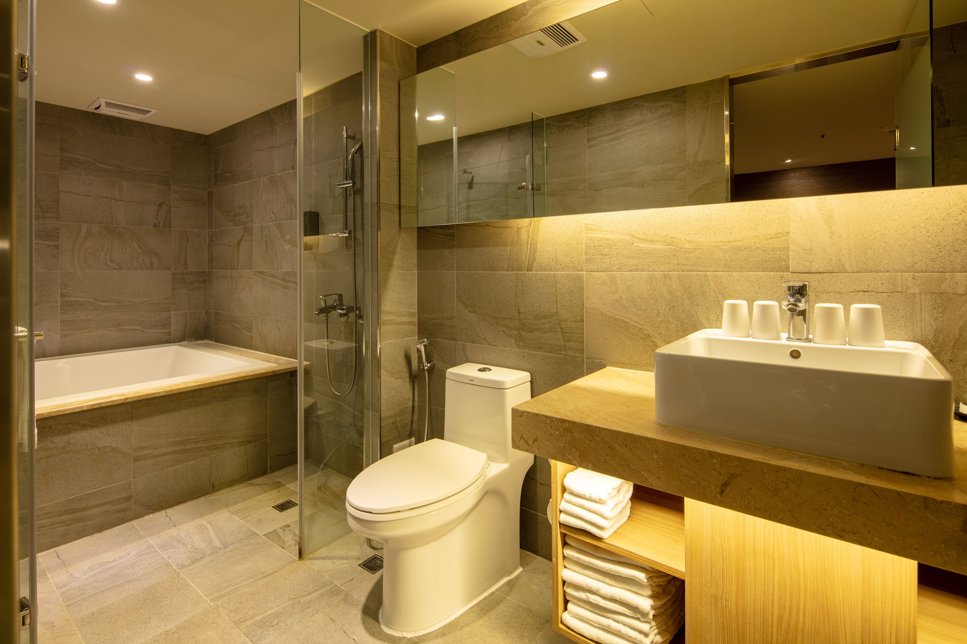 deluxe quadruple room | bathroom | hair dryer, slippers, towels, shampoo