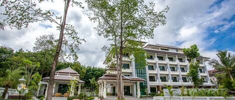 A modern hotel with a central courtyard, multiple floors, and a mix of indoor and outdoor spaces.