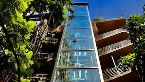 Un edificio moderno con facciata in vetro e diversi balconi.