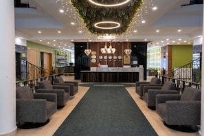 A hotel lobby with a reception desk, seating area, and a staircase. - The Green Oasis Otel & Spa (Yalova)