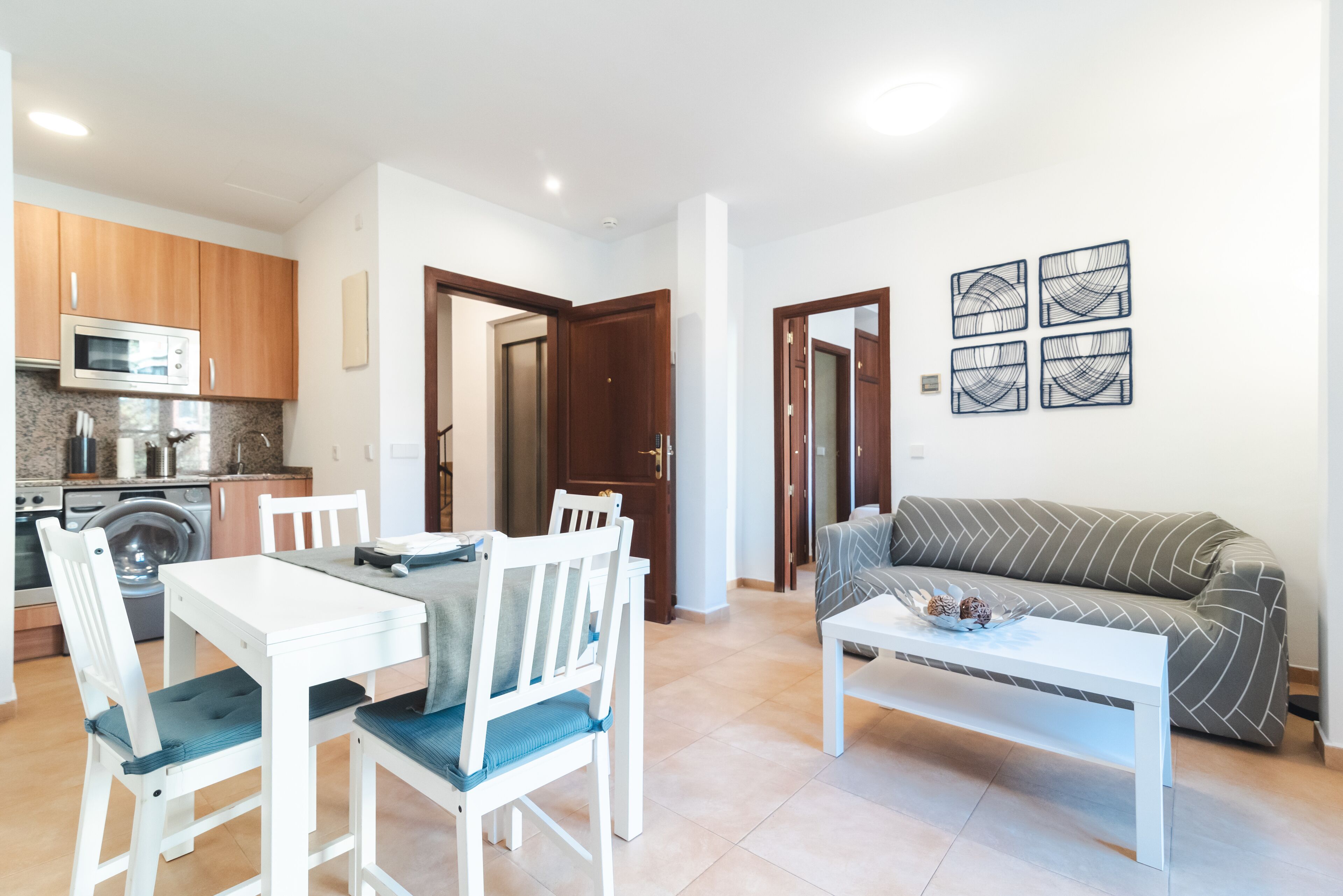 A compact living space with a kitchen, dining area, and a living room.