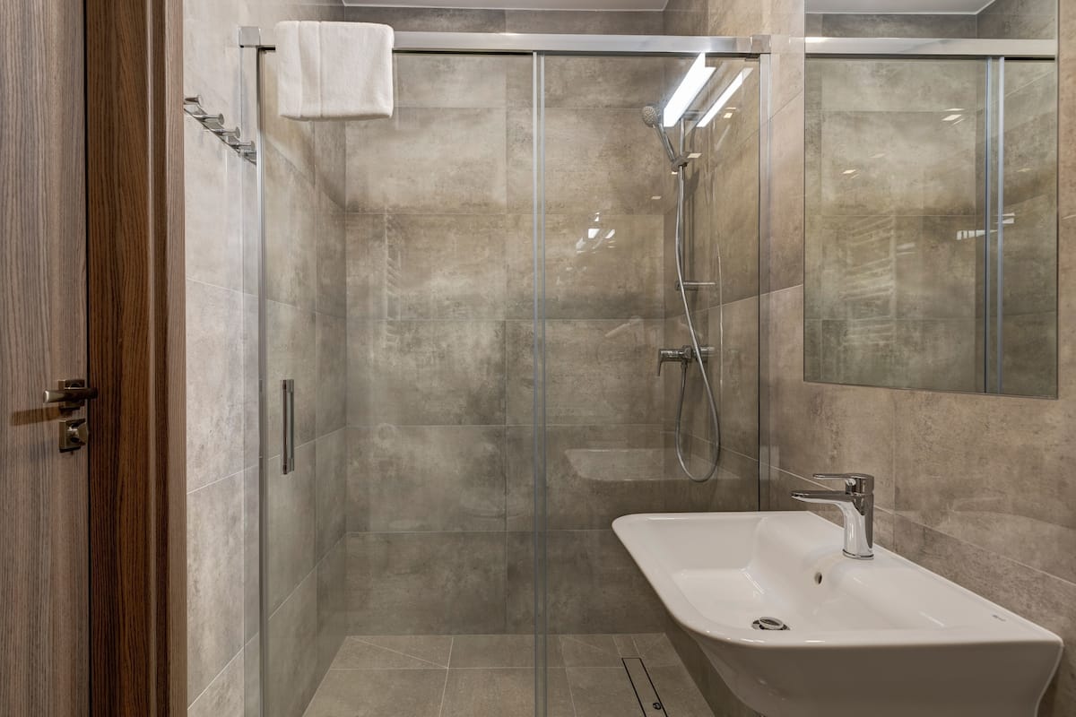 family room | bathroom | shower, free toiletries, hair dryer, slippers