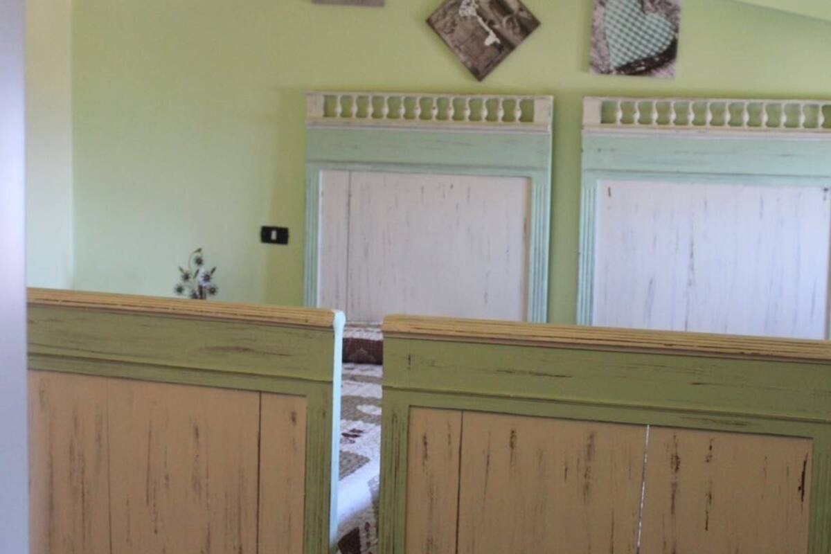 A room with two wooden cabinets, a white air conditioning unit, and a small decorative item on the wall.