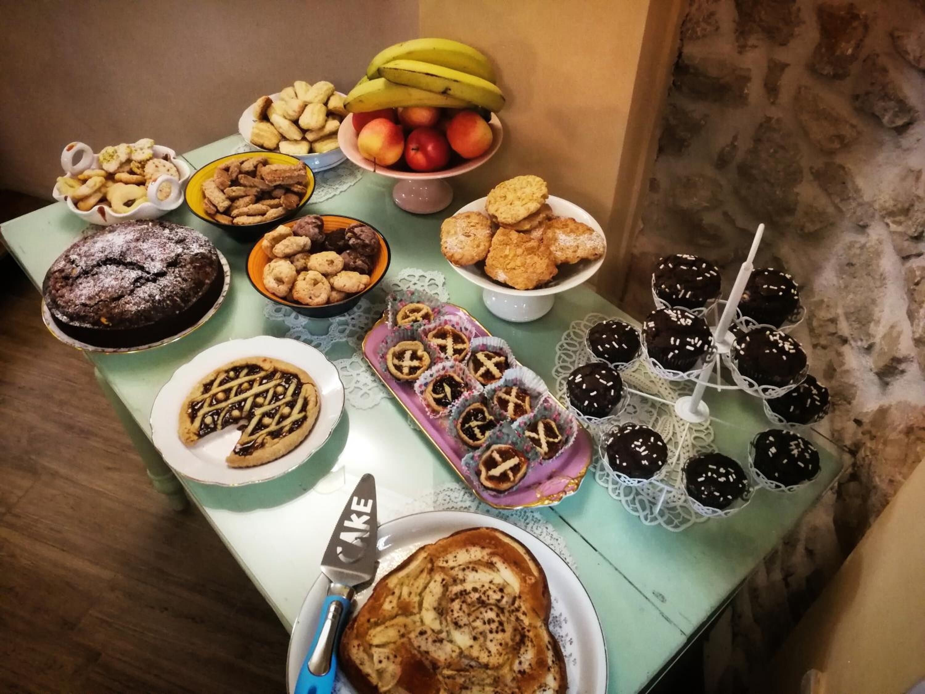 A table with various desserts and fruits.