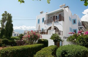 A two-story building with a balcony and a sign that reads "Moonlight Hotel". - Moonlight Hotel (Hersonissos)