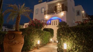 A two-story building with a balcony and a blue-lit archway at the entrance. - Moonlight Hotel (Hersonissos)