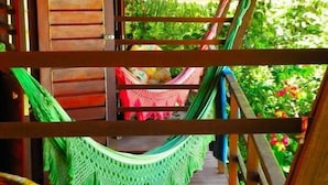 A wooden staircase with a hammock and a woven basket.