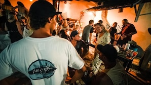 A crowded indoor social event with people standing and interacting.