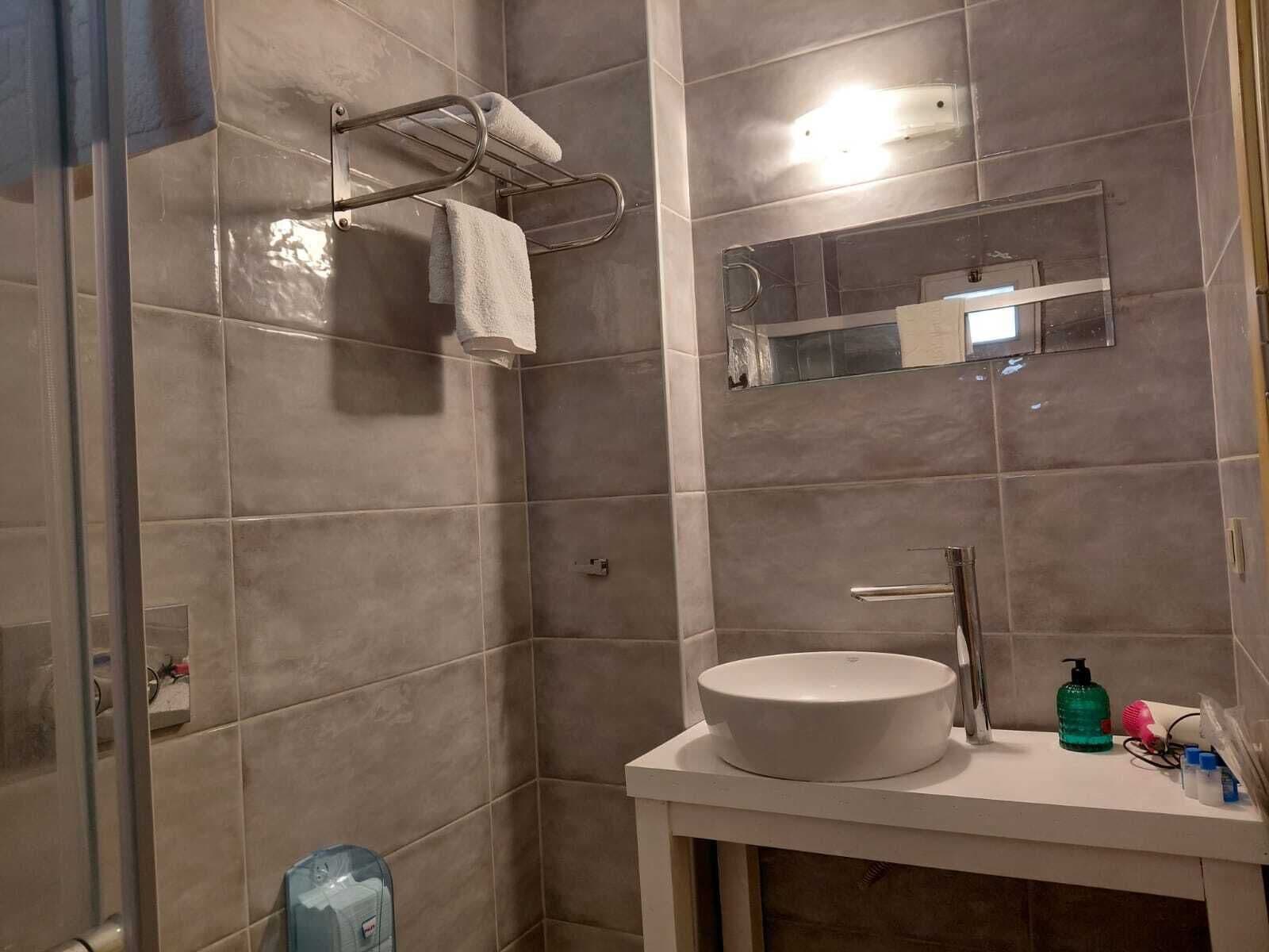 economy room | bathroom | shower, free toiletries, hair dryer, slippers