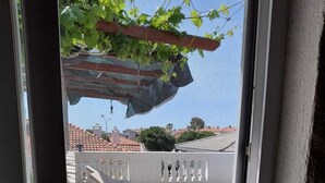 Un balcon avec une piscine, des chaises longues et une pergola couverte de plantes grimpantes.