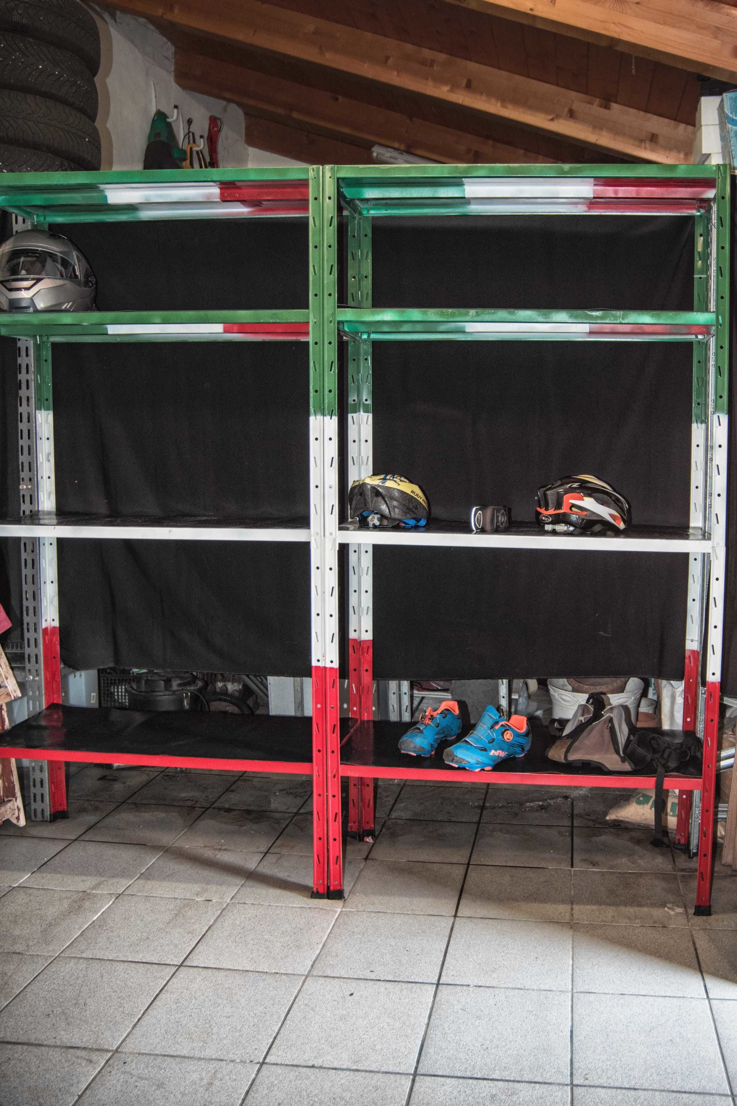A metal shelving unit with three shelves, some items on the top shelf, and a pair of blue shoes on the bottom shelf.