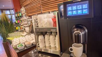 A coffee machine with a digital display and a coffee dispenser.