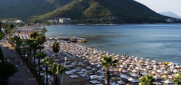 On the beach, sun-loungers, beach umbrellas, beach towels