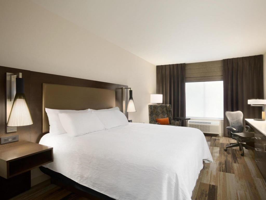 Premium bedding, desk, laptop workspace, blackout drapes
