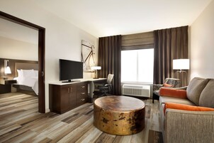 Premium bedding, desk, laptop workspace, blackout drapes