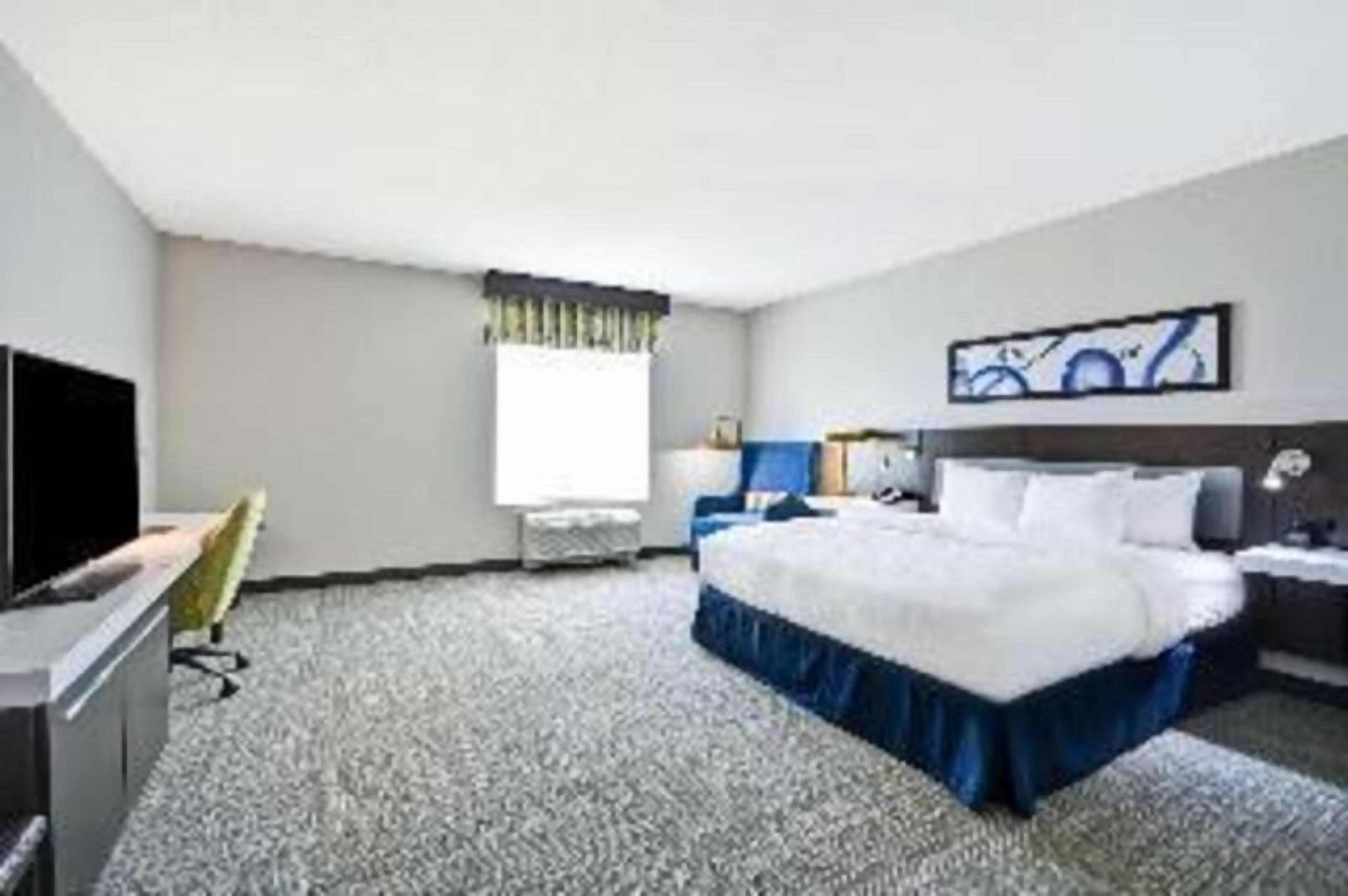 Hypo-allergenic bedding, desk, laptop workspace, blackout drapes