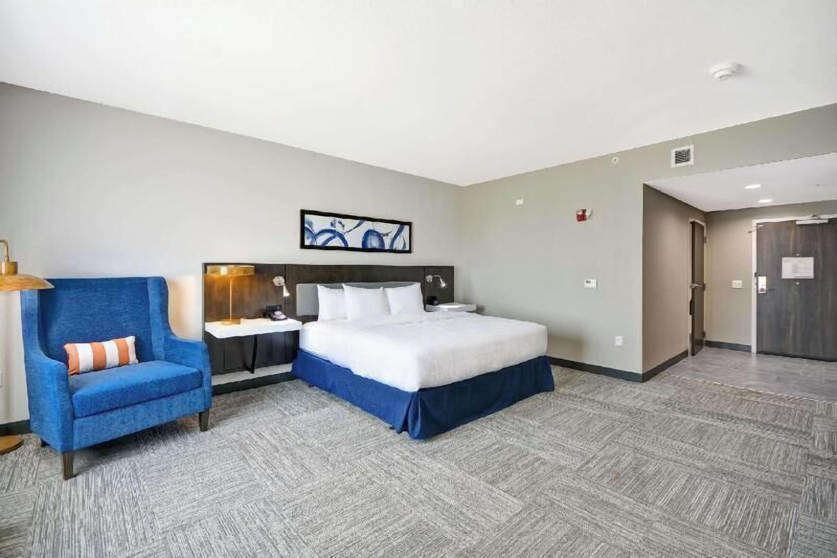Hypo-allergenic bedding, desk, laptop workspace, blackout drapes