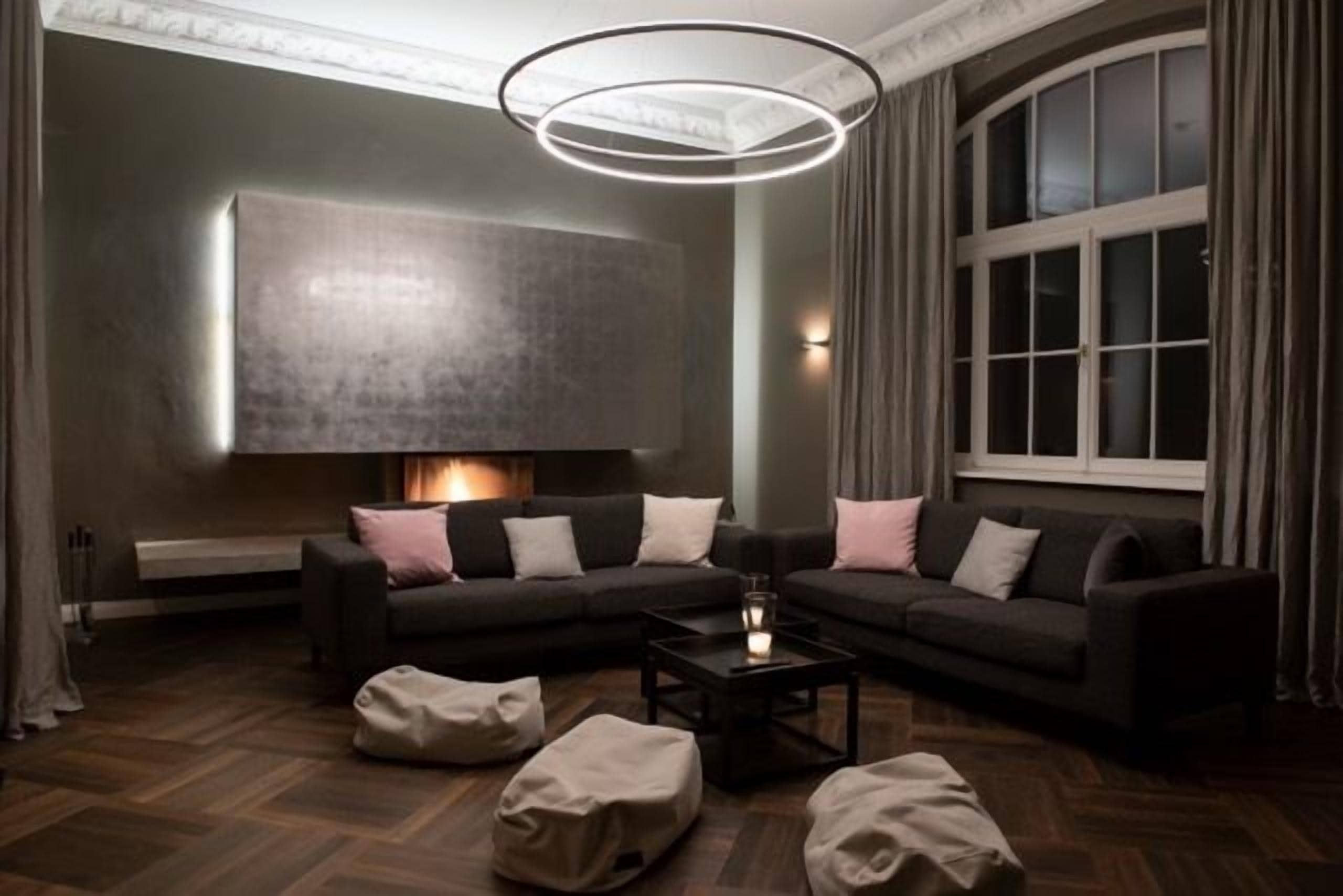 A modern living room with a sectional sofa, a coffee table, and a fireplace.