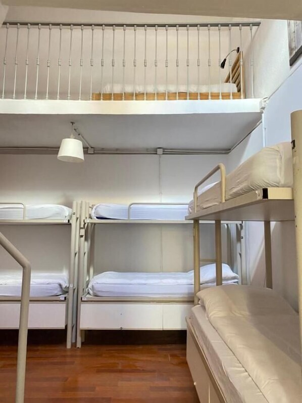 A bunk bed room with a ceiling fan, wooden flooring, and a window with blinds. - Safestay Lisbon Bairro Alto (Lisbon)