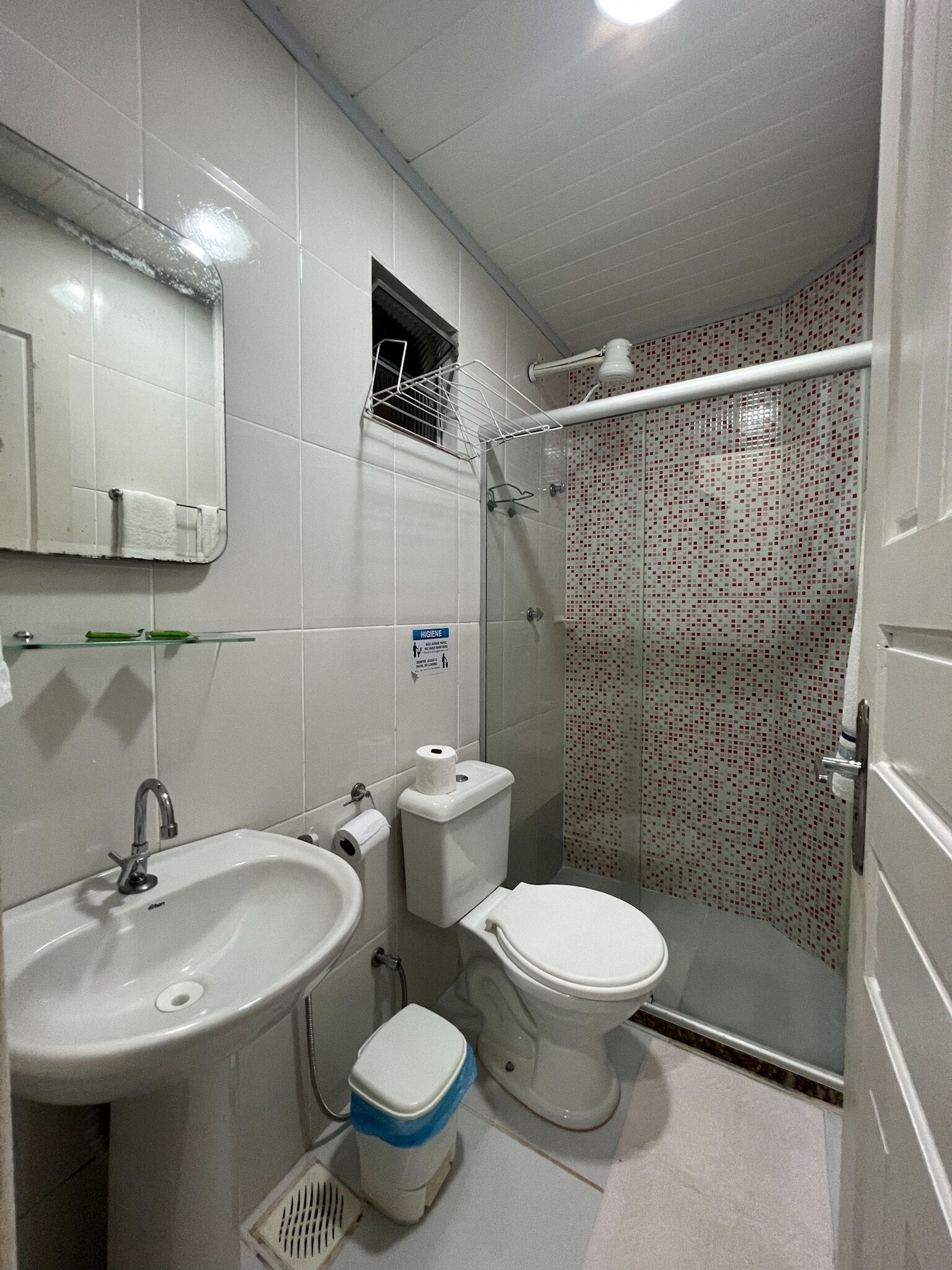 A bathroom with a sink, toilet, and shower.
