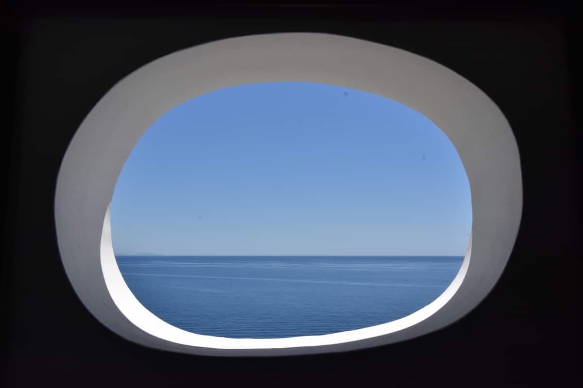 A window with a view of the sea.
