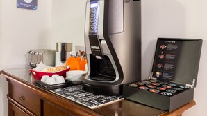 A coffee machine with a selection menu, a bread basket, and a coffee cup on a counter. - B&B 2 Passi Al Colosseo (Rome)