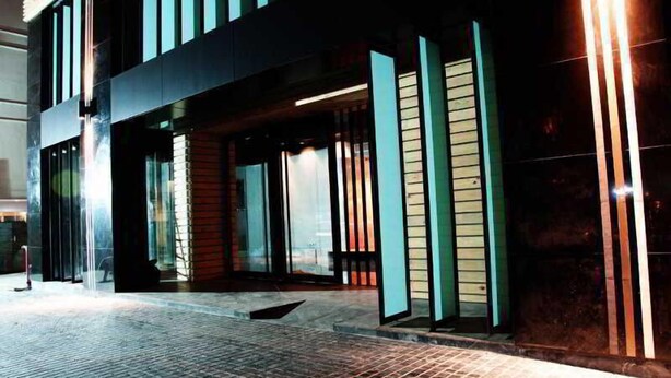 A modern building with a glass facade and vertical light strips. - Bangkok City Hotel (Bangkok)