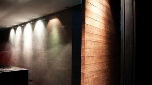 A hallway with wooden paneling and recessed lighting. - Bangkok City Hotel (Bangkok)
