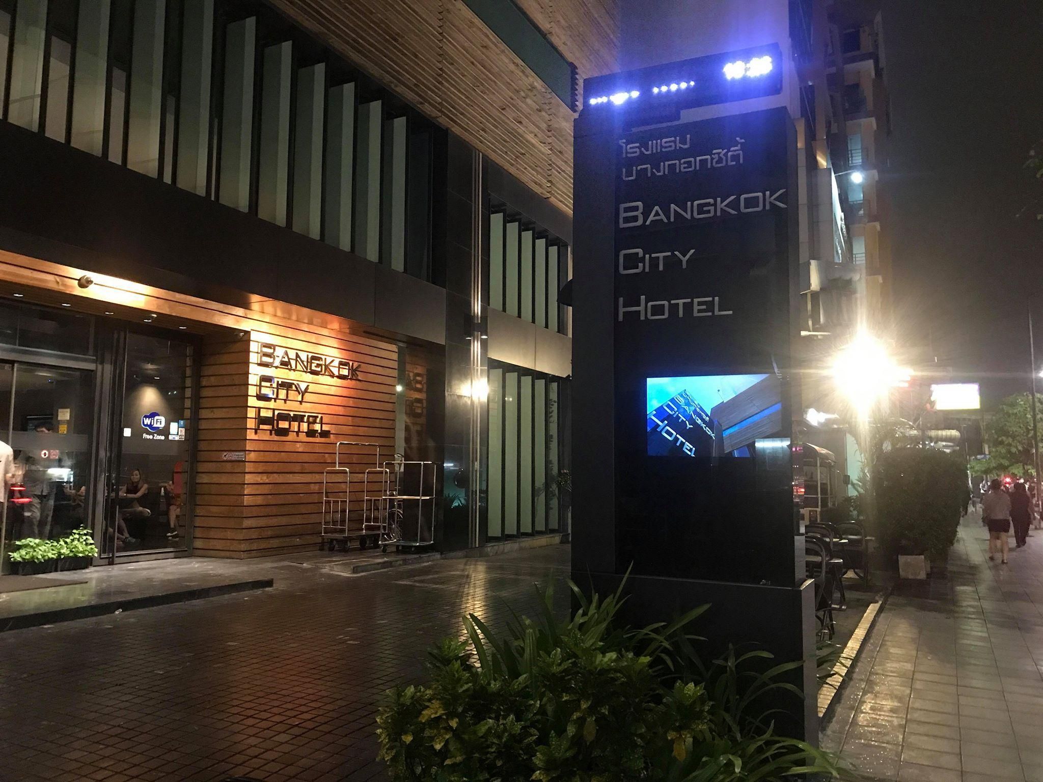 A modern building with a sign for Bangkok City Hotel.