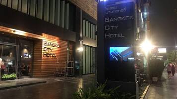 A modern building with a sign for Bangkok City Hotel.