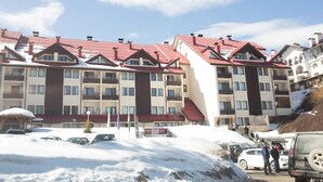 A multi-story hotel with a red roof and a central entrance. - Laplandia Hotel (Smolyan)