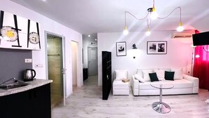 A modern apartment with a kitchen, dining area, and living room. - Large Deluxe Studio in MiniSmart RedZebra Complex (Balchik)