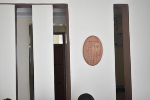 Simple, clean design with a circular plaque and a door with a vertical panel.