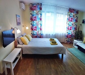 Relax in comfort with a large bed, flat-screen TV, and cozy reading nook.