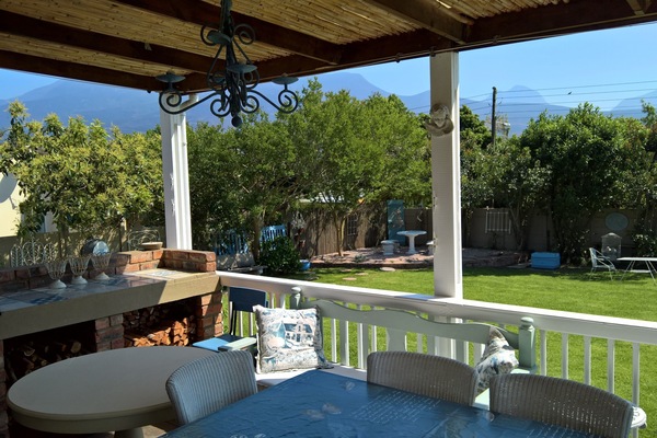 View from the veranda onto the enclosed garden and mountains in the background