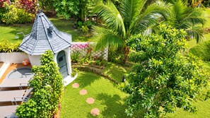A garden with a gazebo, palm trees, and a pool area. - Luxury Private pool Villa Nap Dau Perfect for Groups (Chalong,Tambon Wichit)