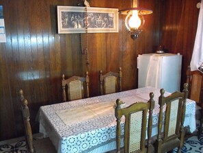 A dining area with a wooden table, lace tablecloth, and wooden chairs. - Stone house GREGOV - family groups ,eco Tourism,direct access on private beach (Lumbarda)