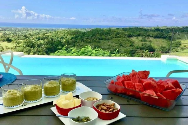 Vila Vertigo overlooks the atlantic ocean and green hills.
