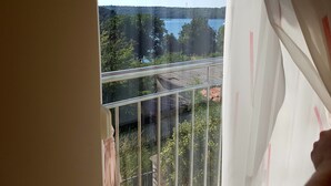 A balcony with a metal railing overlooking a body of water, trees, and a distant hill. - MARTINA 3-star*** Apartment with POOL (Banjole)