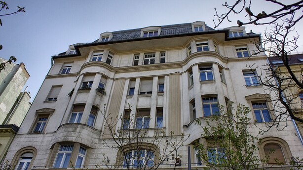 A large, historic building with multiple windows and balconies, featuring classical architectural elements. - Deluxe apartment with super Wifi in city center (Budapest)