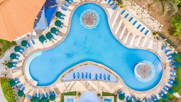 Relax by the resort's central pool, surrounded by smaller pools and comfortable seating areas.
