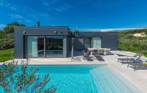 A modern house with a swimming pool, large glass windows, and outdoor furniture. - Villa Lagoderan Rovinj (Rovinj)
