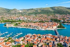 A coastal town with a marina, historic buildings, and a prominent church tower.