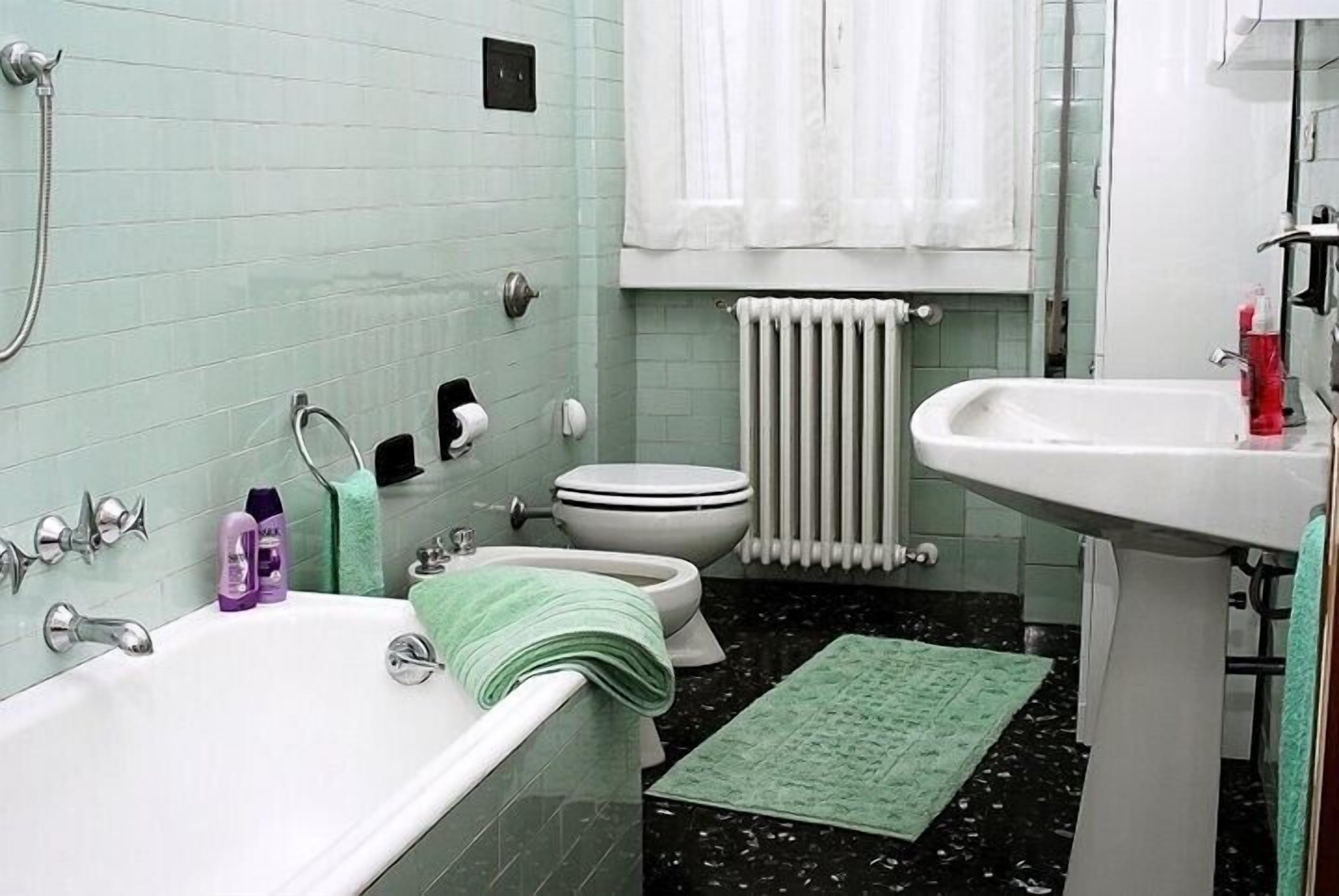 Ein Badezimmer mit einer Badewanne, Toilette und Waschbecken.